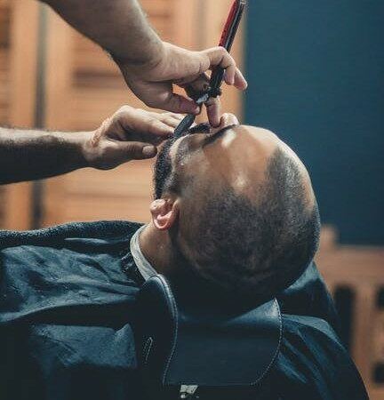 Barber using razor on client